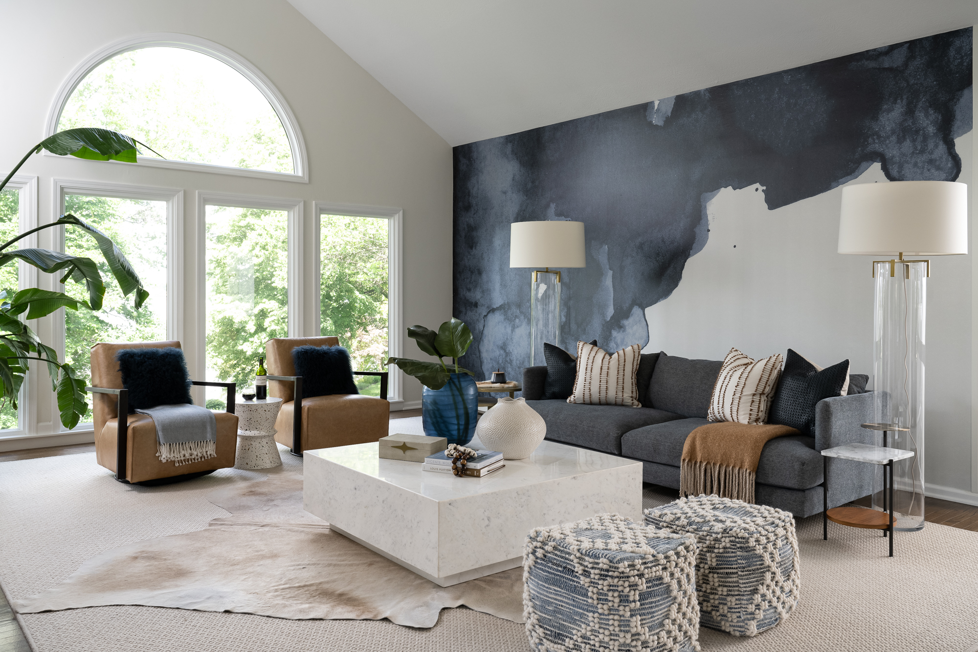 Beautiful navy blue watercolor mural covers the right wall with caramel colored seating.